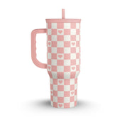 Pink and white checkered tumbler with heart patterns on a white background