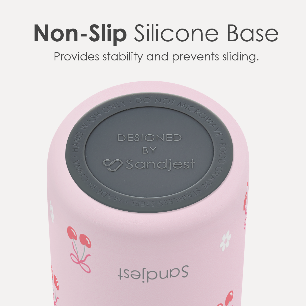 Pink tumbler with gray non-slip silicone base on a white background, featuring Sandjest branding.