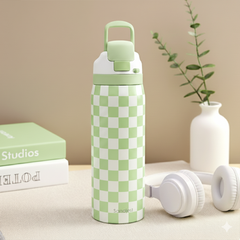 Green and white checkered water bottle with a matching cap on a beige surface.