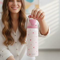 Woman holding a pink water bottle with heart pattern