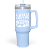 A blue 40oz stainless steel insulated tumbler with a handle and a printed text 'A sister is God's way of making sure we never walk alone.'.