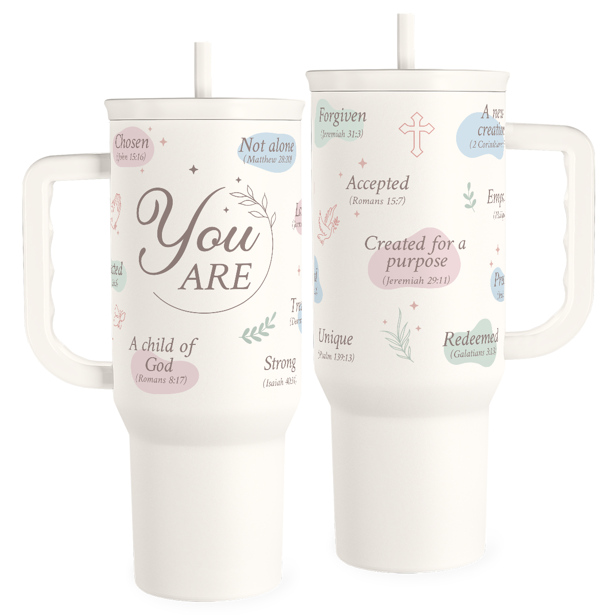 Two white insulated stainless steel tumblers with handles and straws, featuring pastel-colored text and designs such as hearts and leaves, with one side showcasing phrases like 'You are', ' Accepted', and 'Forgiven'.