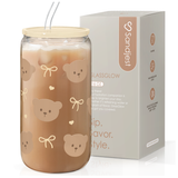 A glass bottle with a bear design, alongside a silicone lid and a straw, packaged in a box with the brand 'Sandjest' visible.